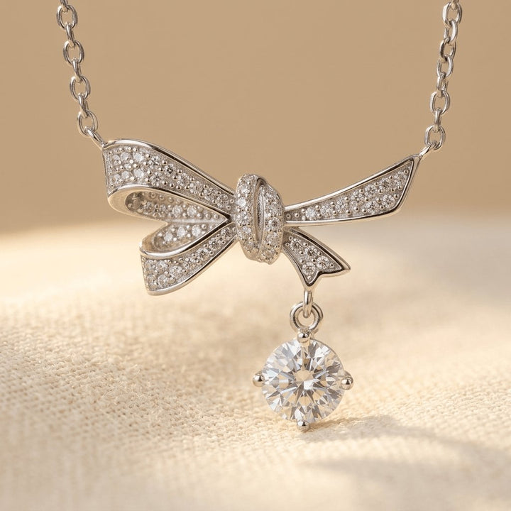 Silver Tone Bow Necklace with Dangling Crystal